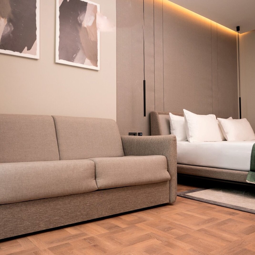 La Brisa Hotel - beige sofa bed facing the bed with a backlit headboard, South Albania