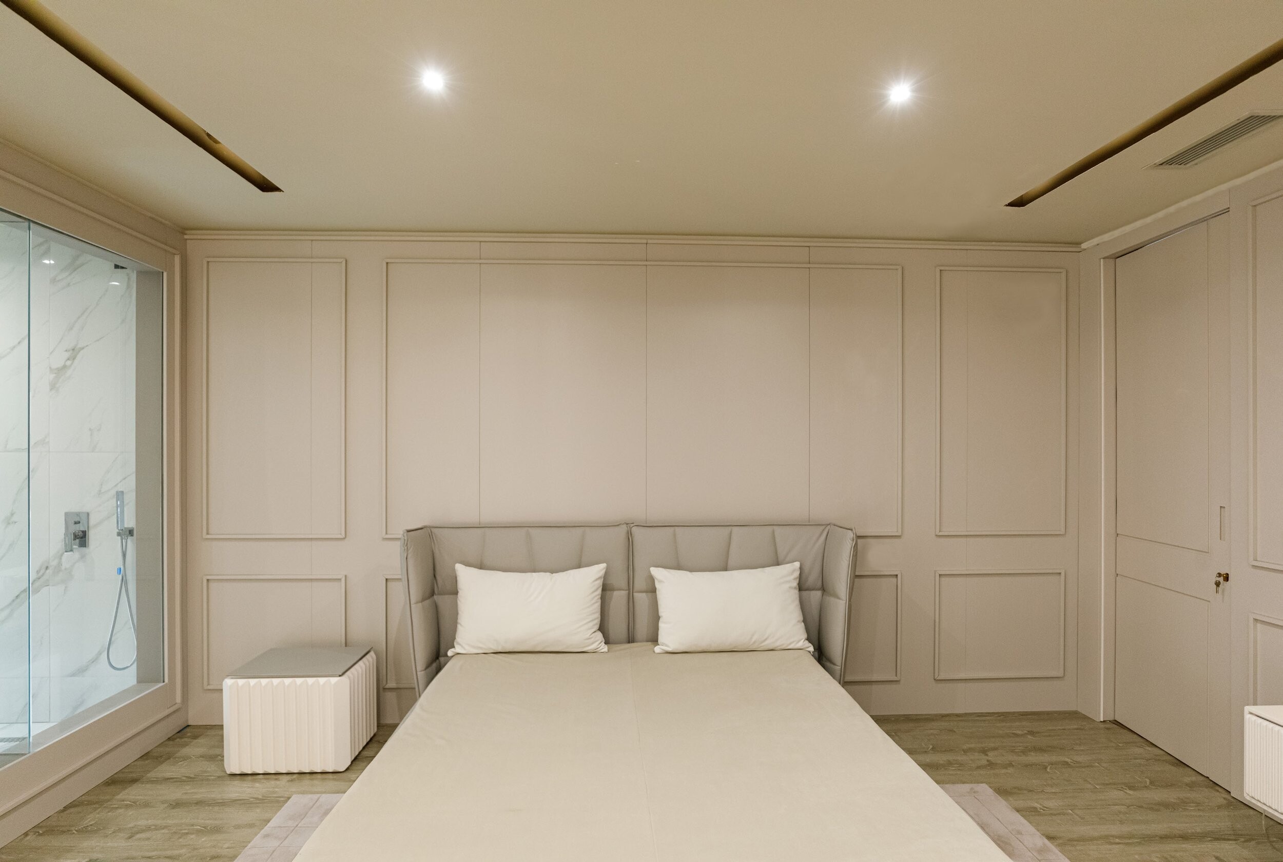 Private Villa South Albania - bedroom with a panelled wall, bed and upholstered stool, Vlore