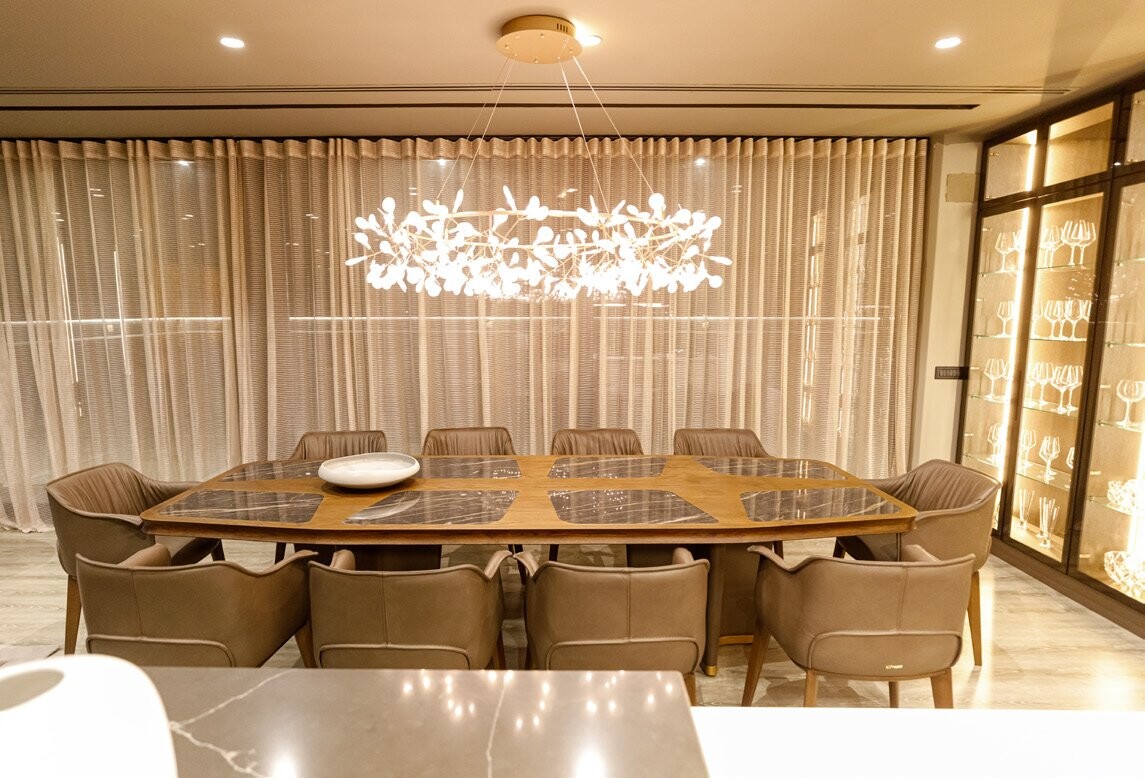 Private Villa South Albania - dining table with upholstered chairs below a cluster chandelier, Vlore